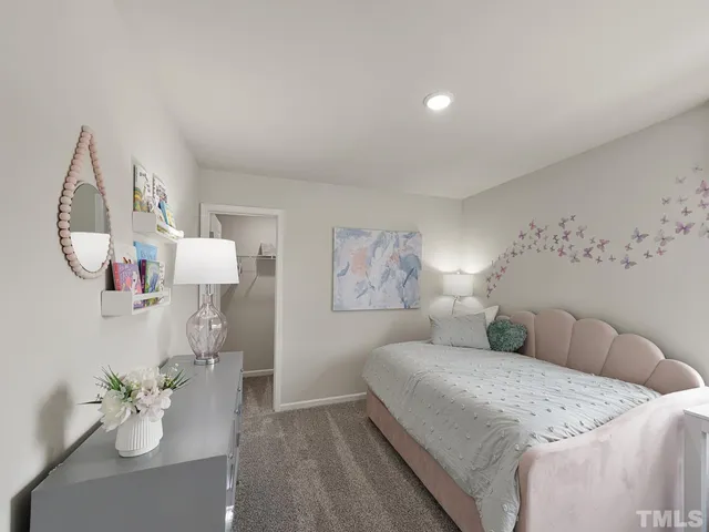 a spacious bedroom with a bed and a chandelier