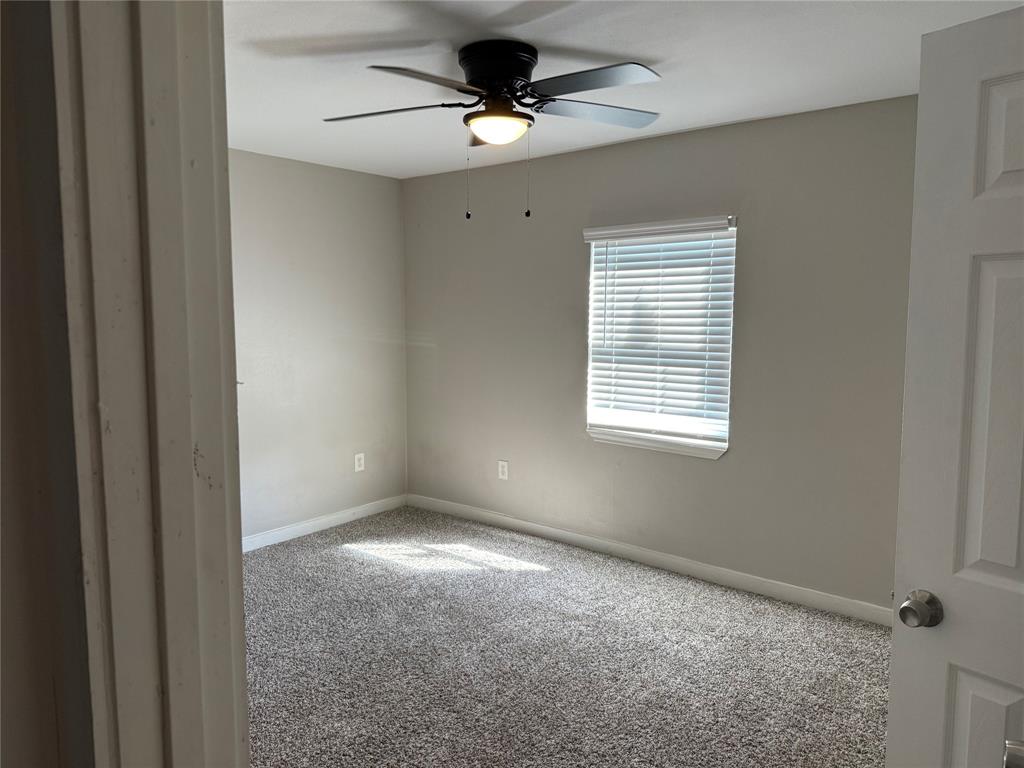 2781 Locust Avenue Dallas, TX 75216 - Photo 12 of 15 a view of a livingroom with a ceiling fan and window