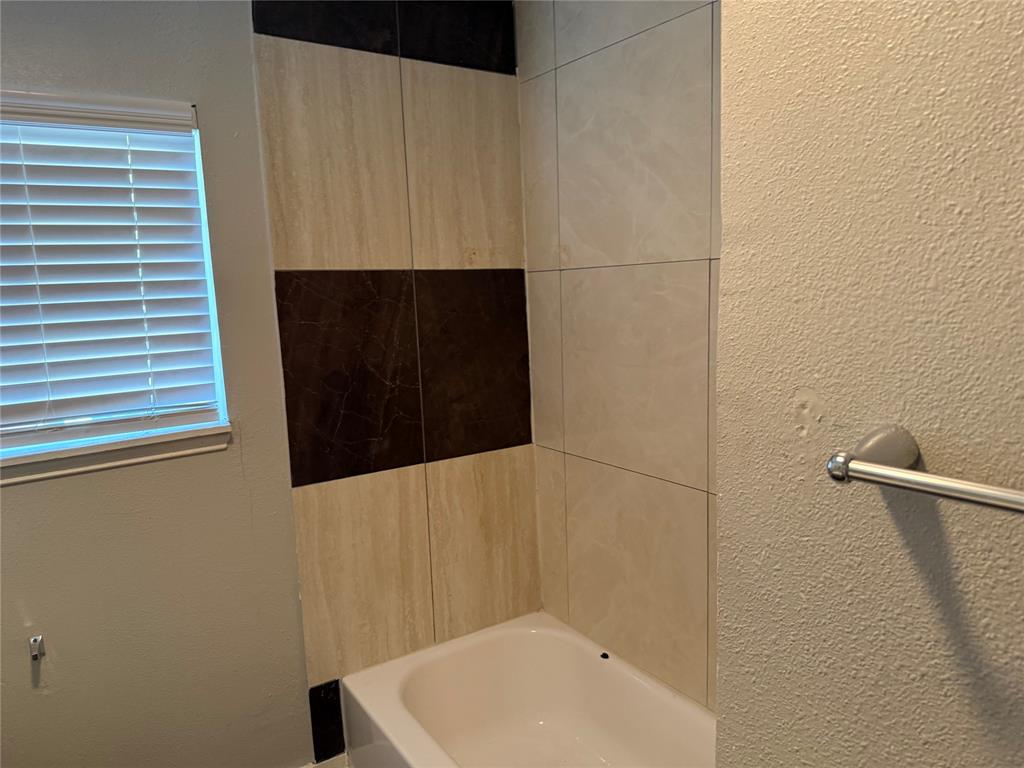 2781 Locust Avenue Dallas, TX 75216 - Photo 15 of 15 a bathroom with a sink and a shower