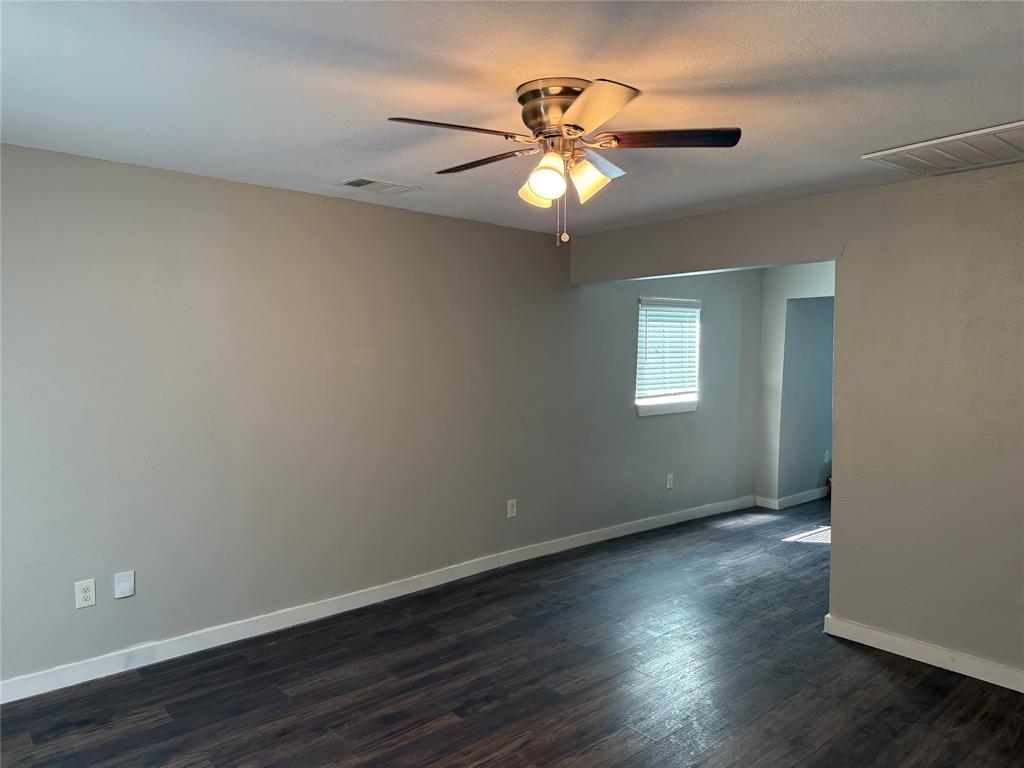 2781 Locust Avenue Dallas, TX 75216 - Photo 4 of 15 a view of an empty room with wooden floor and a fan
