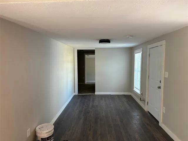 a view of a room with wooden floor and white walls