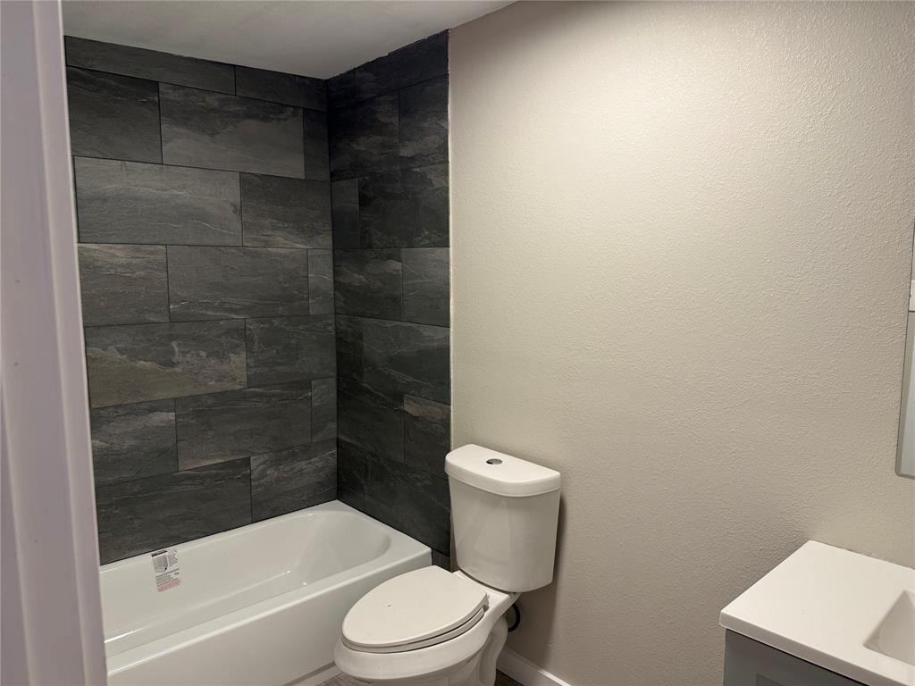 2781 Locust Avenue Dallas, TX 75216 - Photo 8 of 15 a white toilet sitting next to a bathtub