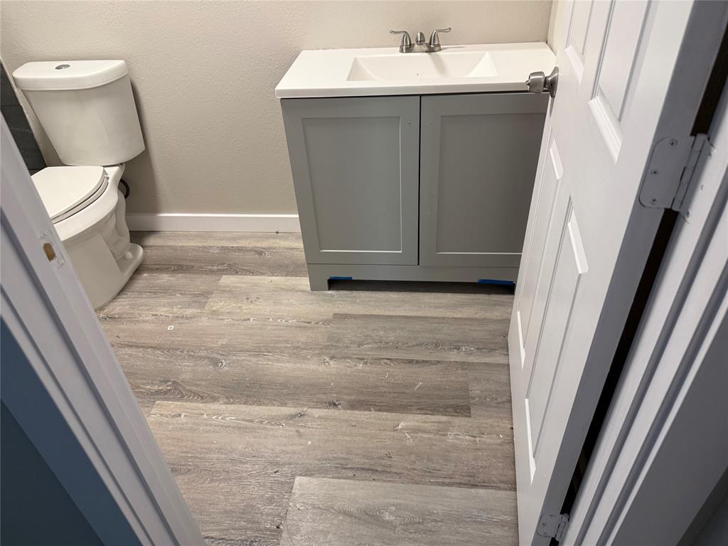 2781 Locust Avenue Dallas, TX 75216 - Photo 9 of 15 a bathroom with toilet sink and mirror