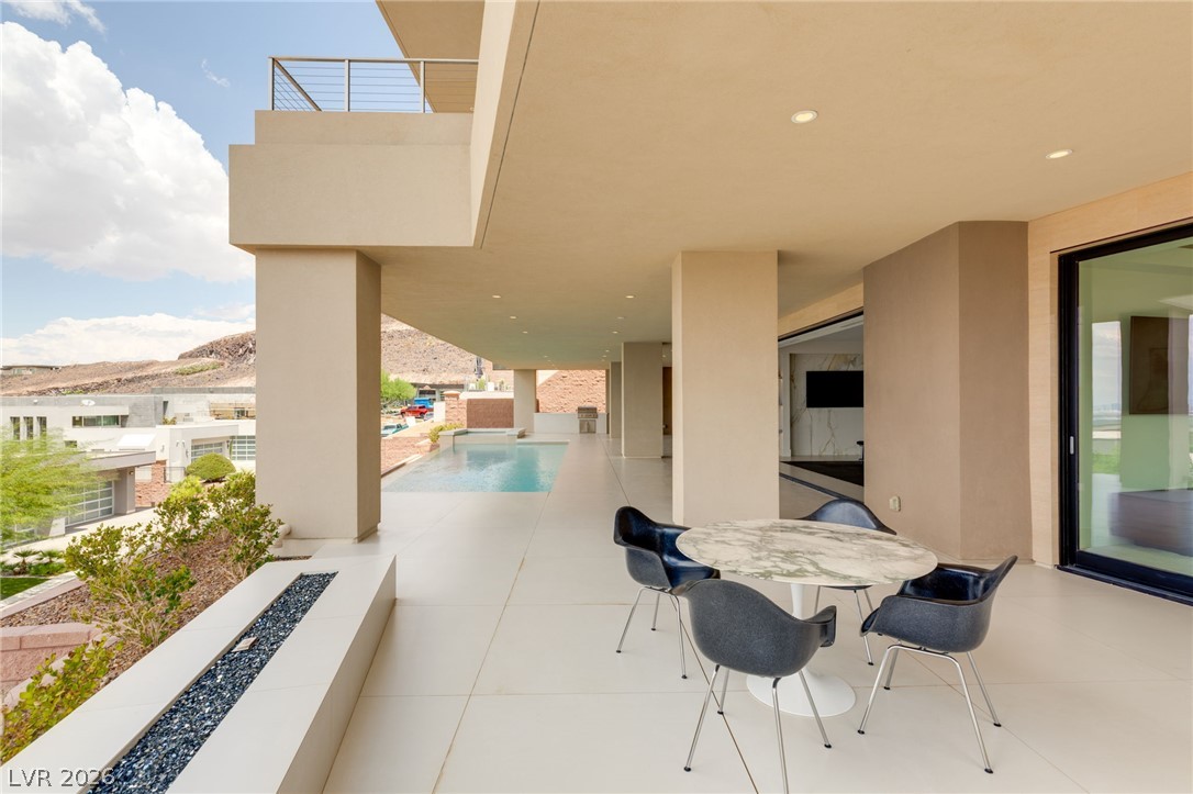 677 Overlook Rim Drive Henderson, NV 89012 - Photo 64 of 97 Smooth tiled flooring runs across this covered outdoor terrace overlooking a private pool.