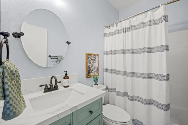 a view of a room with wooden floor and fan