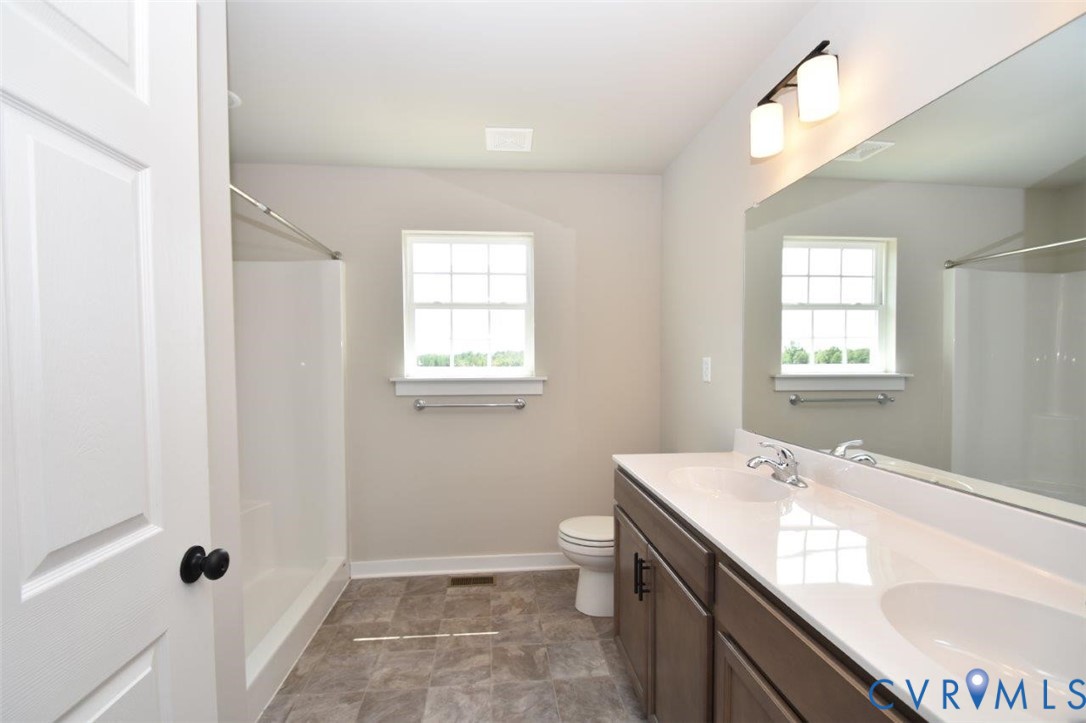 1088 Hanback Road Gordonsville, VA 22942 - Photo 11 of 26 a bathroom with a granite countertop sink a toilet and shower
