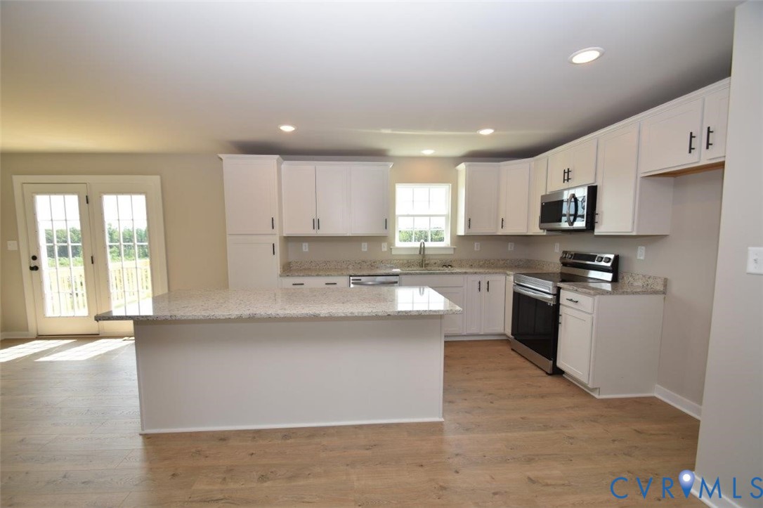 1088 Hanback Road Gordonsville, VA 22942 - Photo 17 of 26 a kitchen with stainless steel appliances granite countertop a stove a sink and a refrigerator