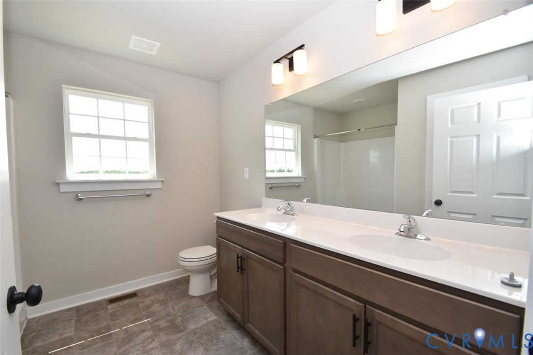 1088 Hanback Road Gordonsville, VA 22942 - Photo 10 of 26 a bathroom with a sink a toilet and a mirror