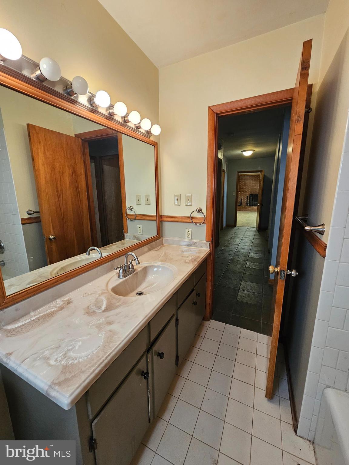 615 Villa Avenue, Unit B Front Royal, VA 22630 - Photo 13 of 21 a bathroom with a granite countertop sink a mirror and a shower