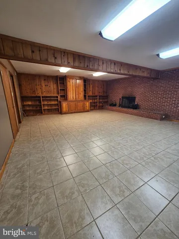 a view of an empty room with a fireplace
