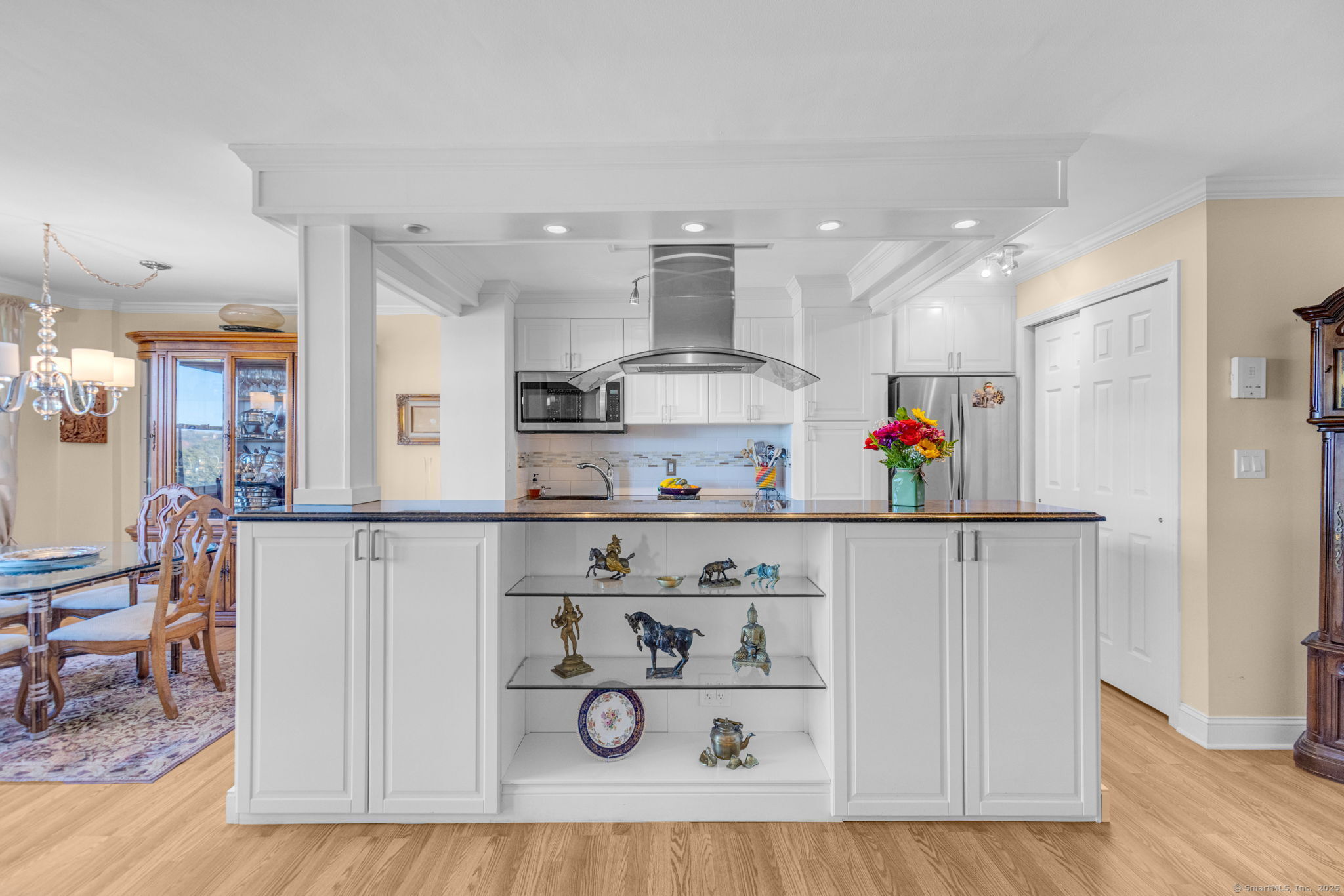 a kitchen with stainless steel appliances granite countertop a refrigerator and a stove top oven