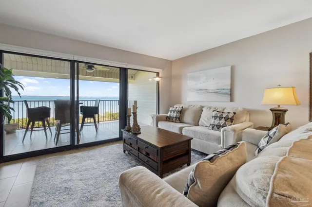a living room with furniture and a floor to ceiling window