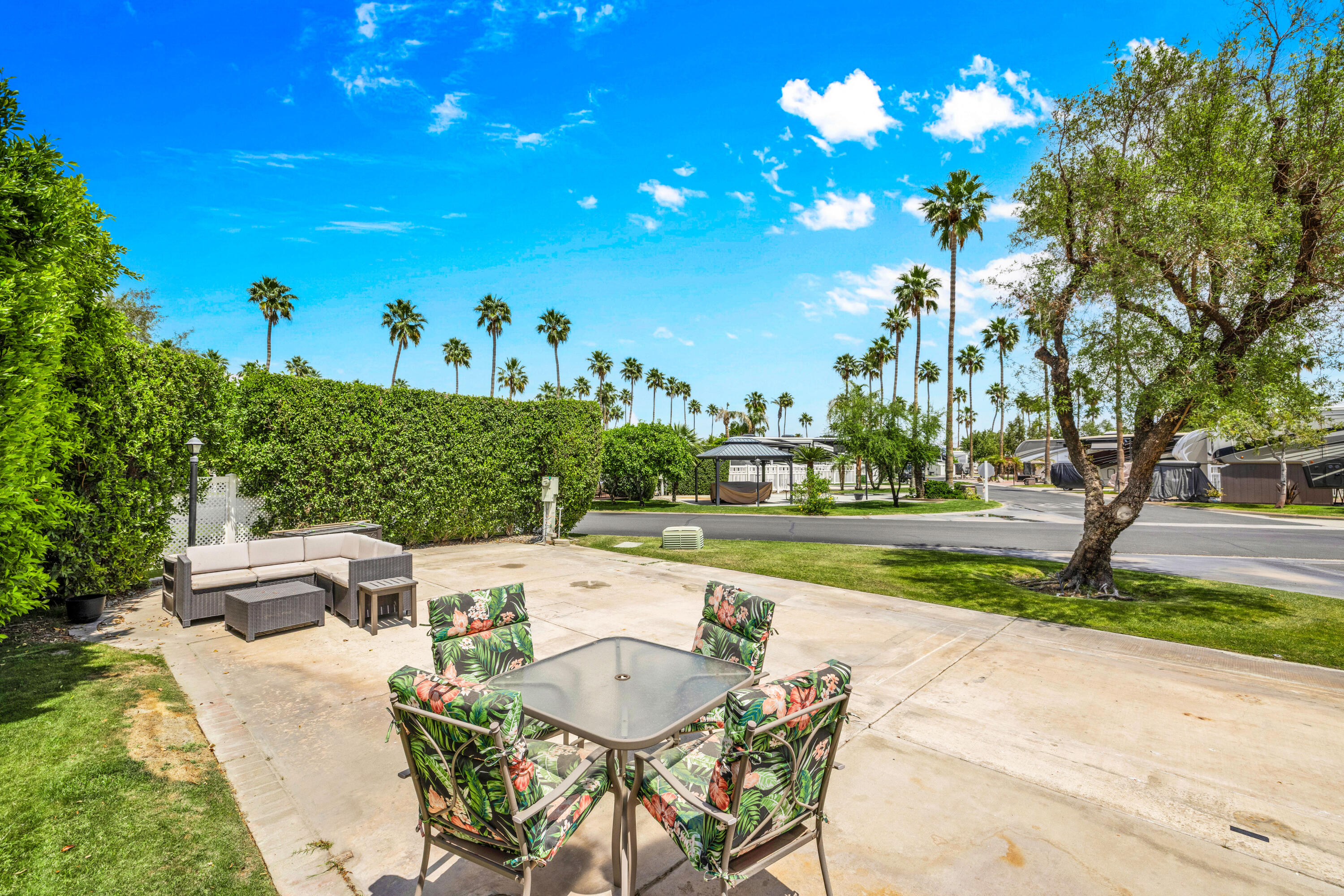 69411 Ramon Road, Unit 359 Cathedral City, CA 92234 - Photo 11 of 51 a view of a patio with table and chairs and a large tree