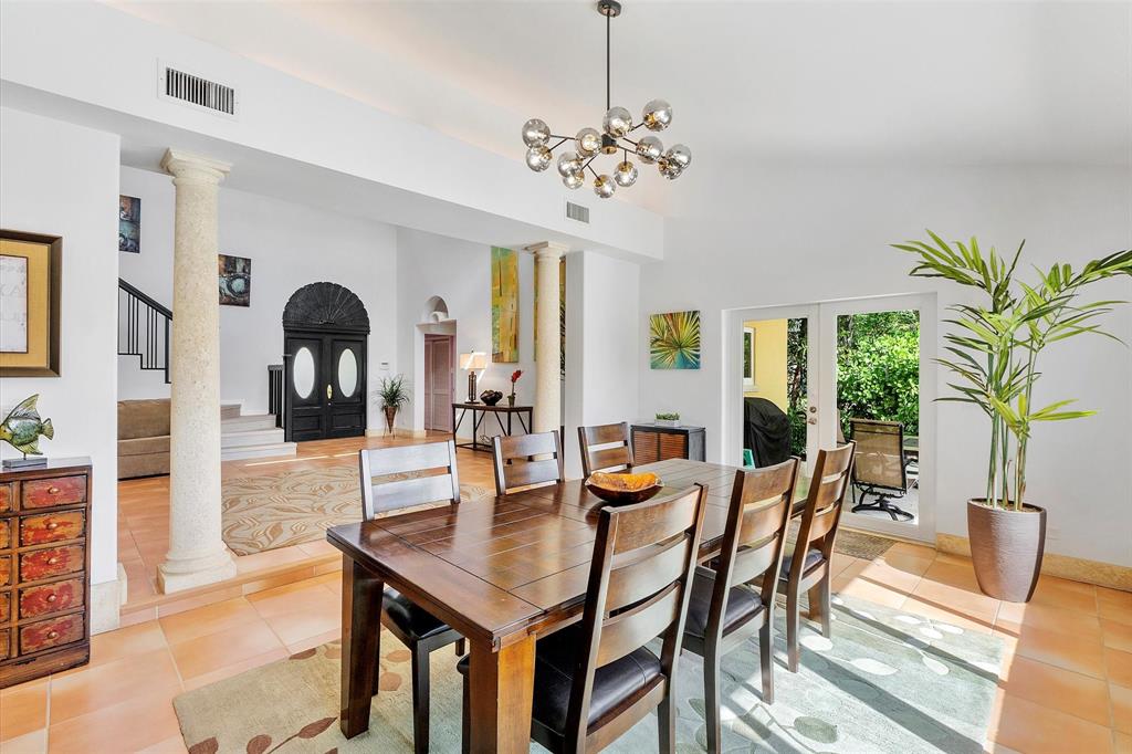2484 Southeast 12th Street Pompano Beach, FL 33062 - Photo 15 of 61 a view of a dining room with furniture a chandelier and wooden floor