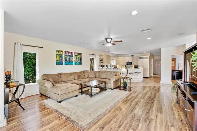 a spacious bedroom with a bed chandelier and window