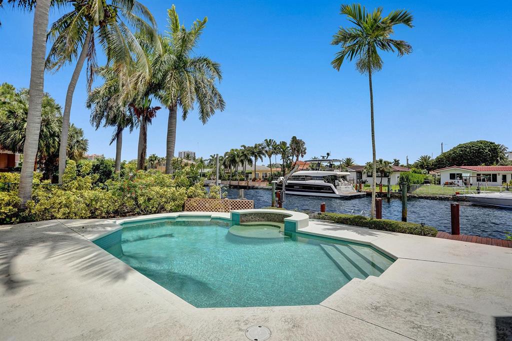 2484 Southeast 12th Street Pompano Beach, FL 33062 - Photo 21 of 61 a swimming pool with outdoor seating and yard