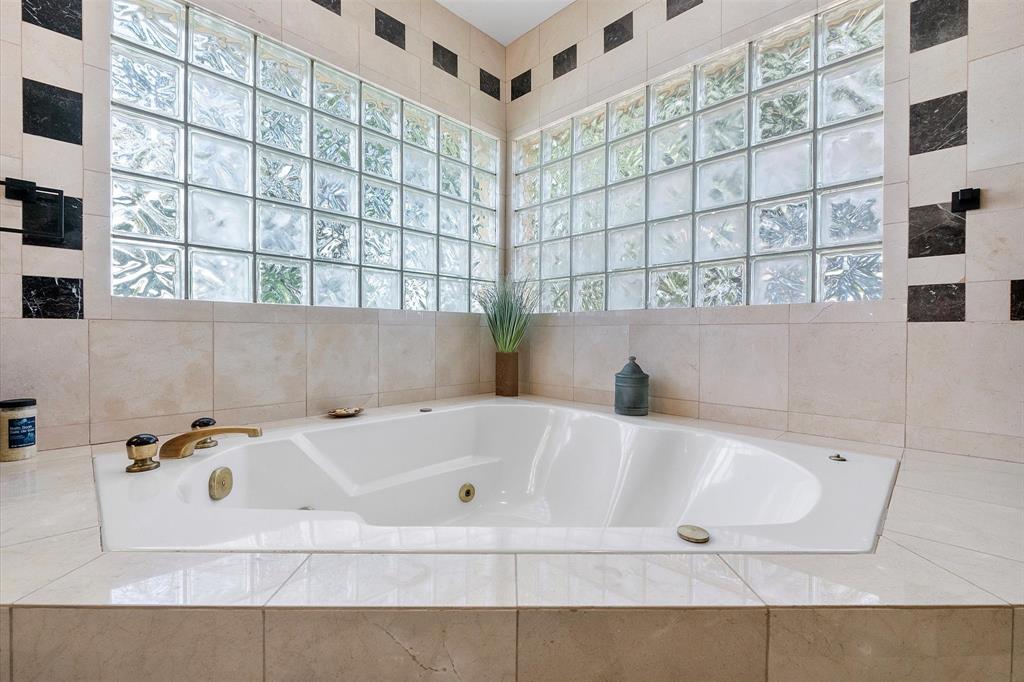 2484 Southeast 12th Street Pompano Beach, FL 33062 - Photo 31 of 61 a bath tub sitting in a bathroom next to a window