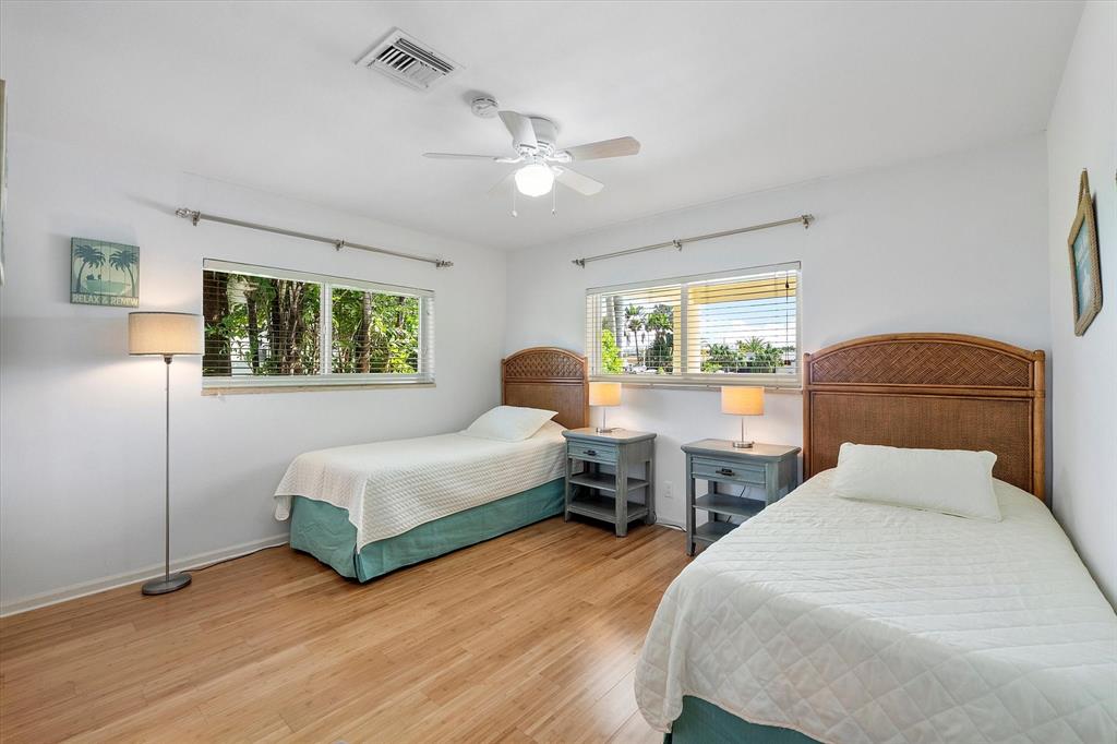 2484 Southeast 12th Street Pompano Beach, FL 33062 - Photo 33 of 61 a bedroom with a bed and wooden floor