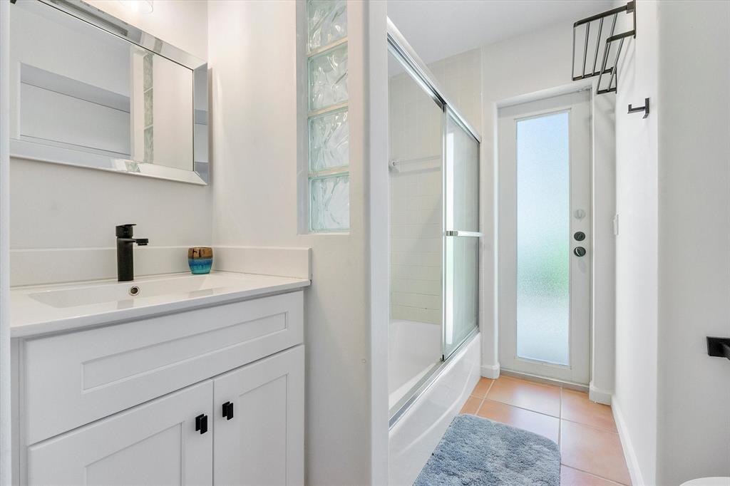 2484 Southeast 12th Street Pompano Beach, FL 33062 - Photo 34 of 61 a bathroom with a shower sink and mirror