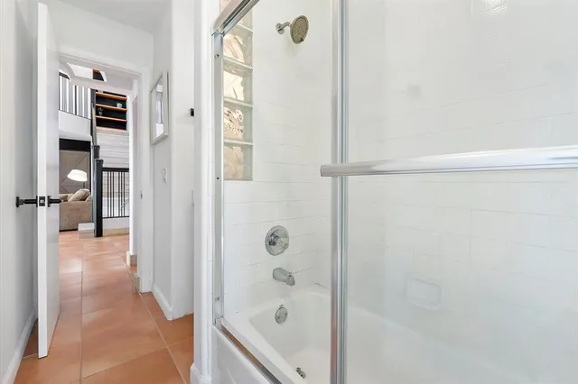 a living room with furniture a flat screen tv and a large window