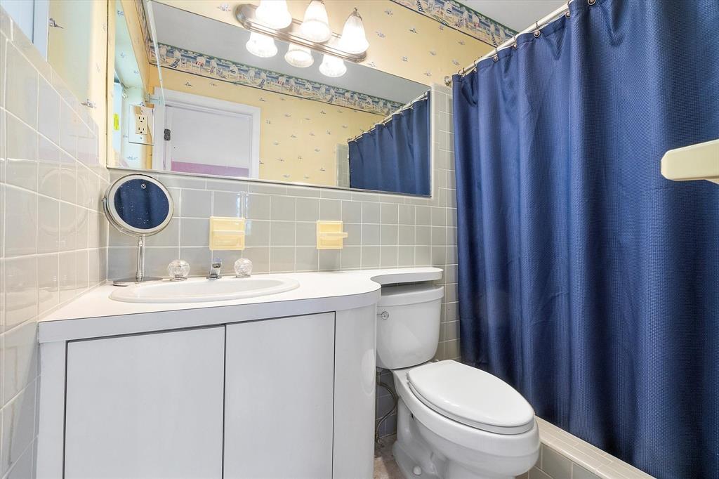 2484 Southeast 12th Street Pompano Beach, FL 33062 - Photo 38 of 61 a bathroom with a sink a toilet and mirror