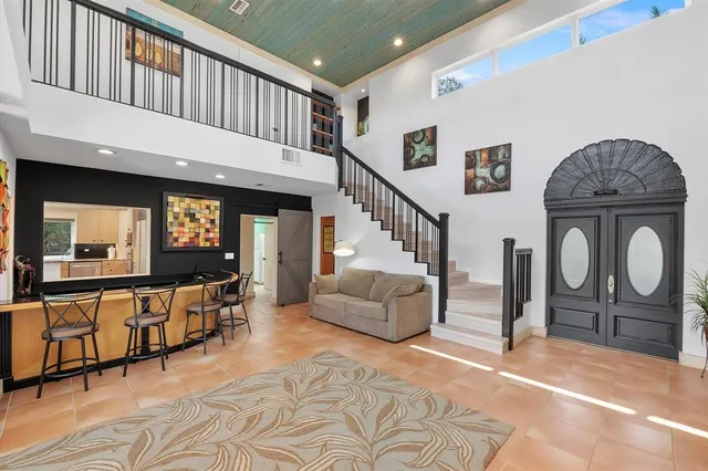 an aerial view of a house with a yard and swimming pool