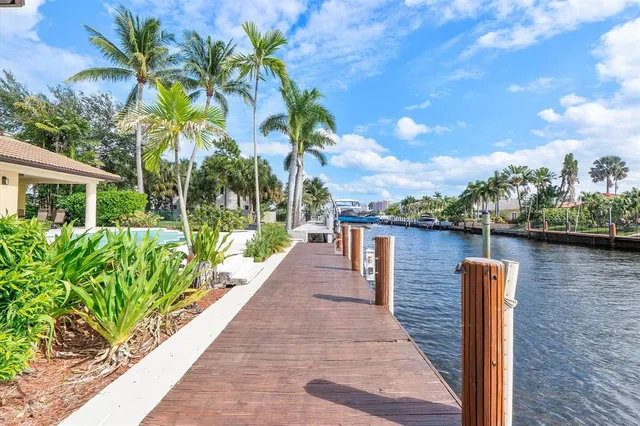 a view of a hallway with dining room and wooden floor