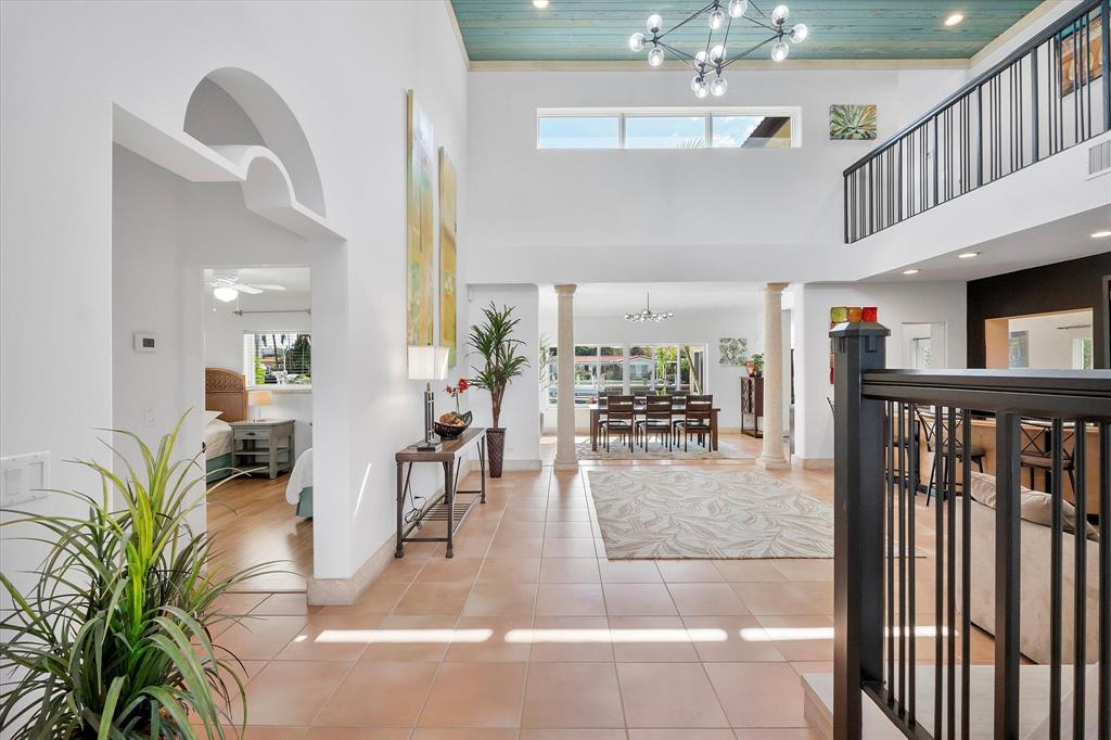 2484 Southeast 12th Street Pompano Beach, FL 33062 - Photo 6 of 61 a view of a hallway with dining room and wooden floor