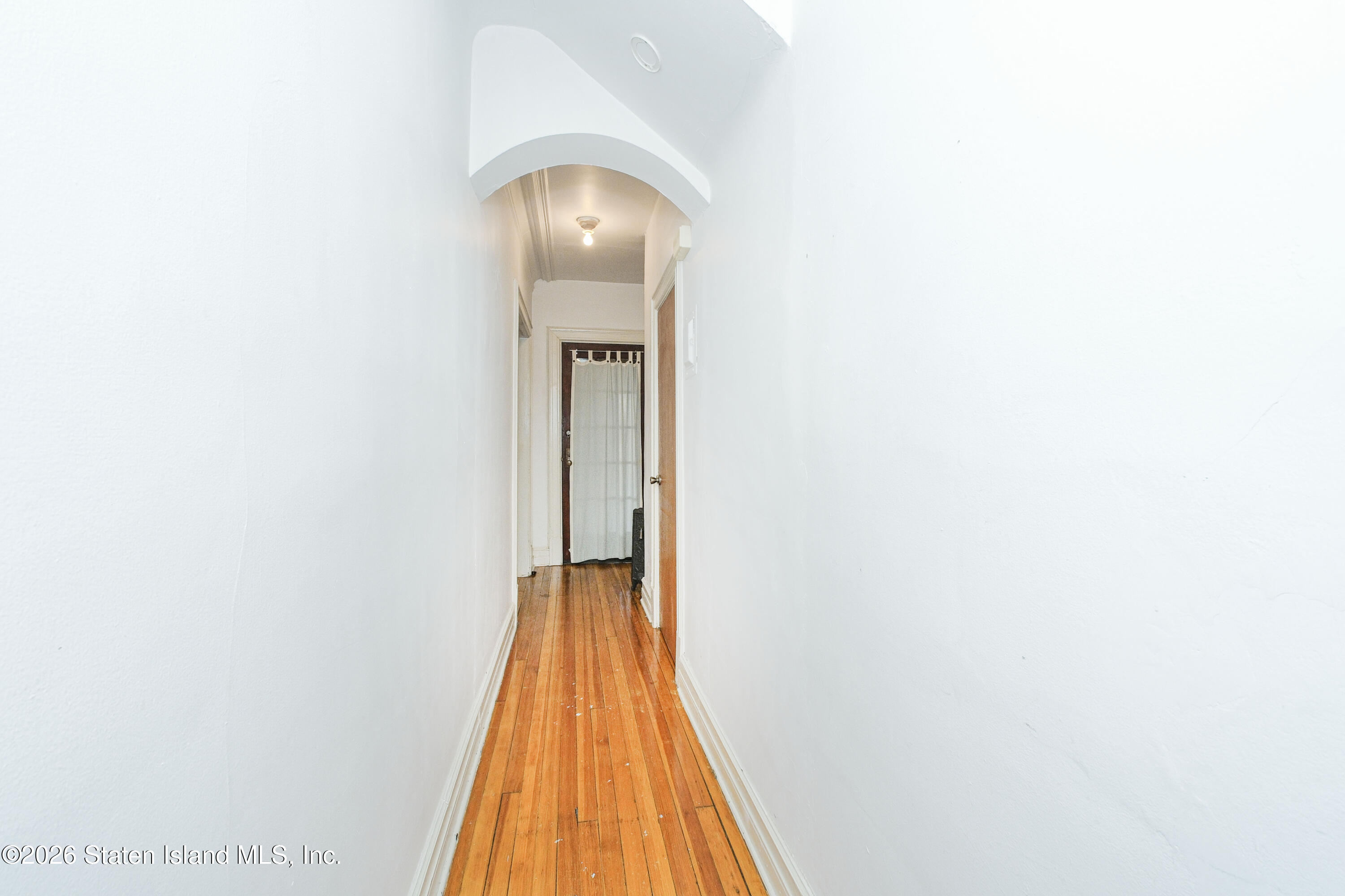 98 Hamilton Avenue Staten Island, NY 10301 - Photo 11 of 55 a view of a hallway with wooden floor