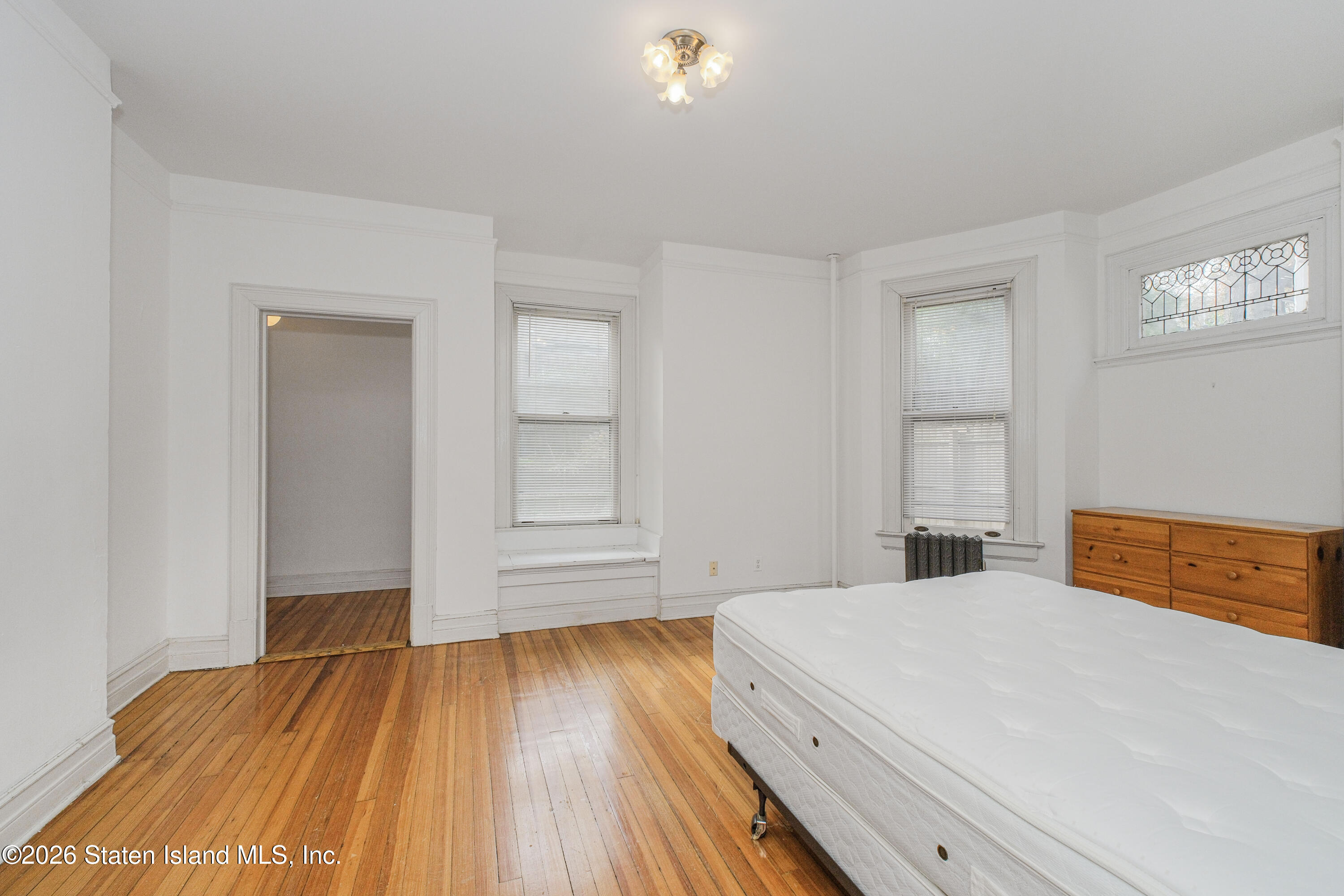 98 Hamilton Avenue Staten Island, NY 10301 - Photo 13 of 55 a bedroom with a bed and a window