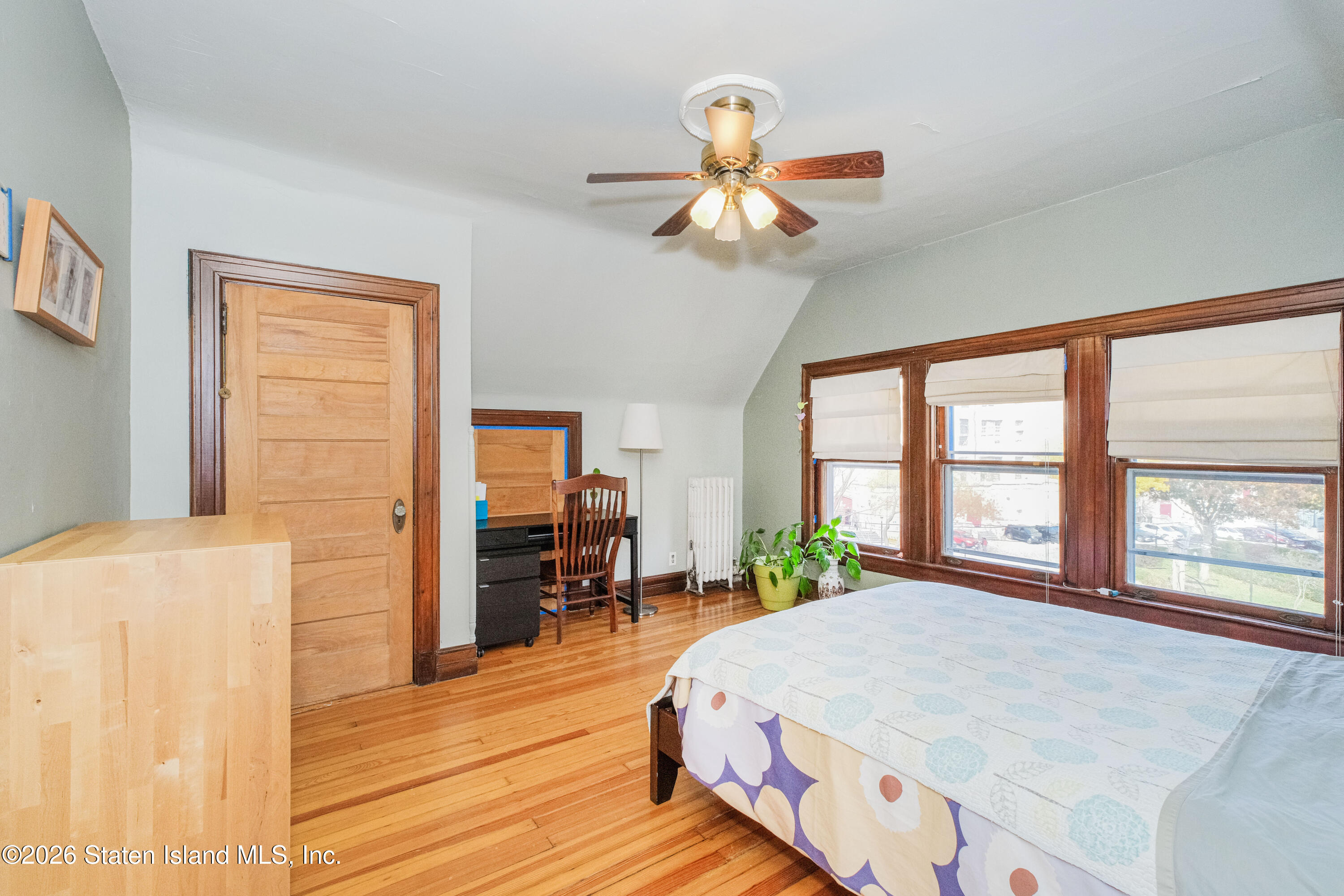 98 Hamilton Avenue Staten Island, NY 10301 - Photo 17 of 55 a bed room with a bed and a chandelier