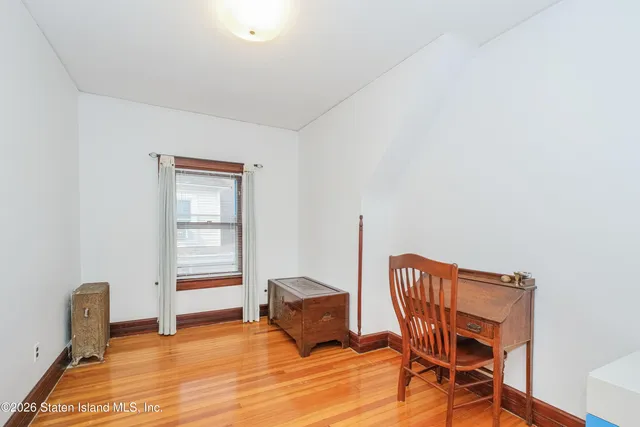 a view of a room with lounge chair and wooden floor