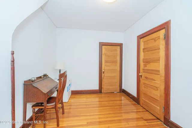 a view of a room with wooden floor and a chair