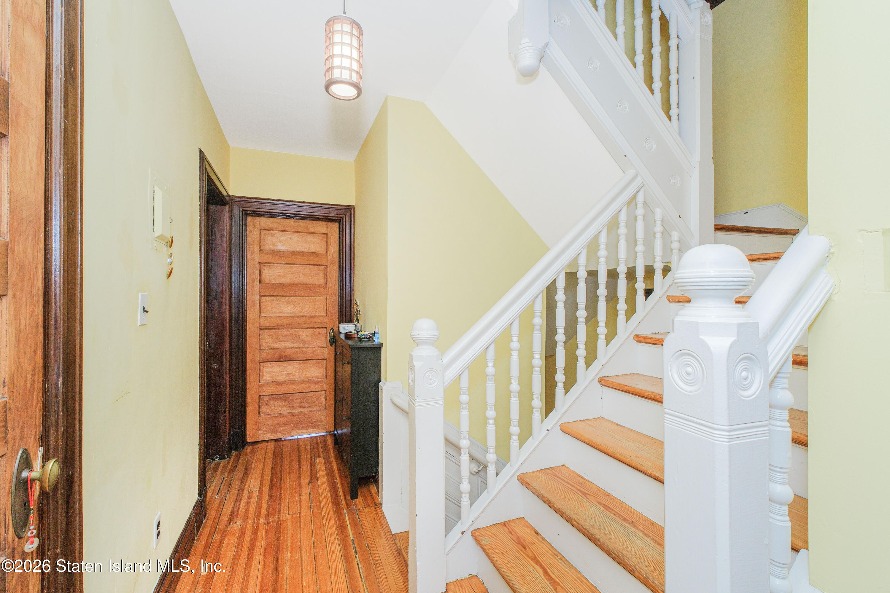 98 Hamilton Avenue Staten Island, NY 10301 - Photo 24 of 55 a view of staircase with wooden floor and a rug