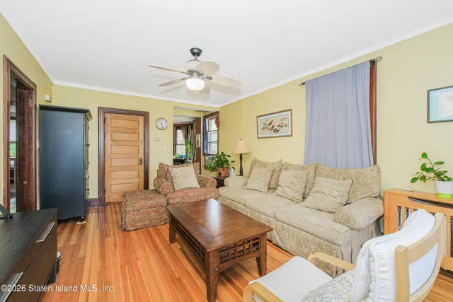 a living room with furniture a rug and a window