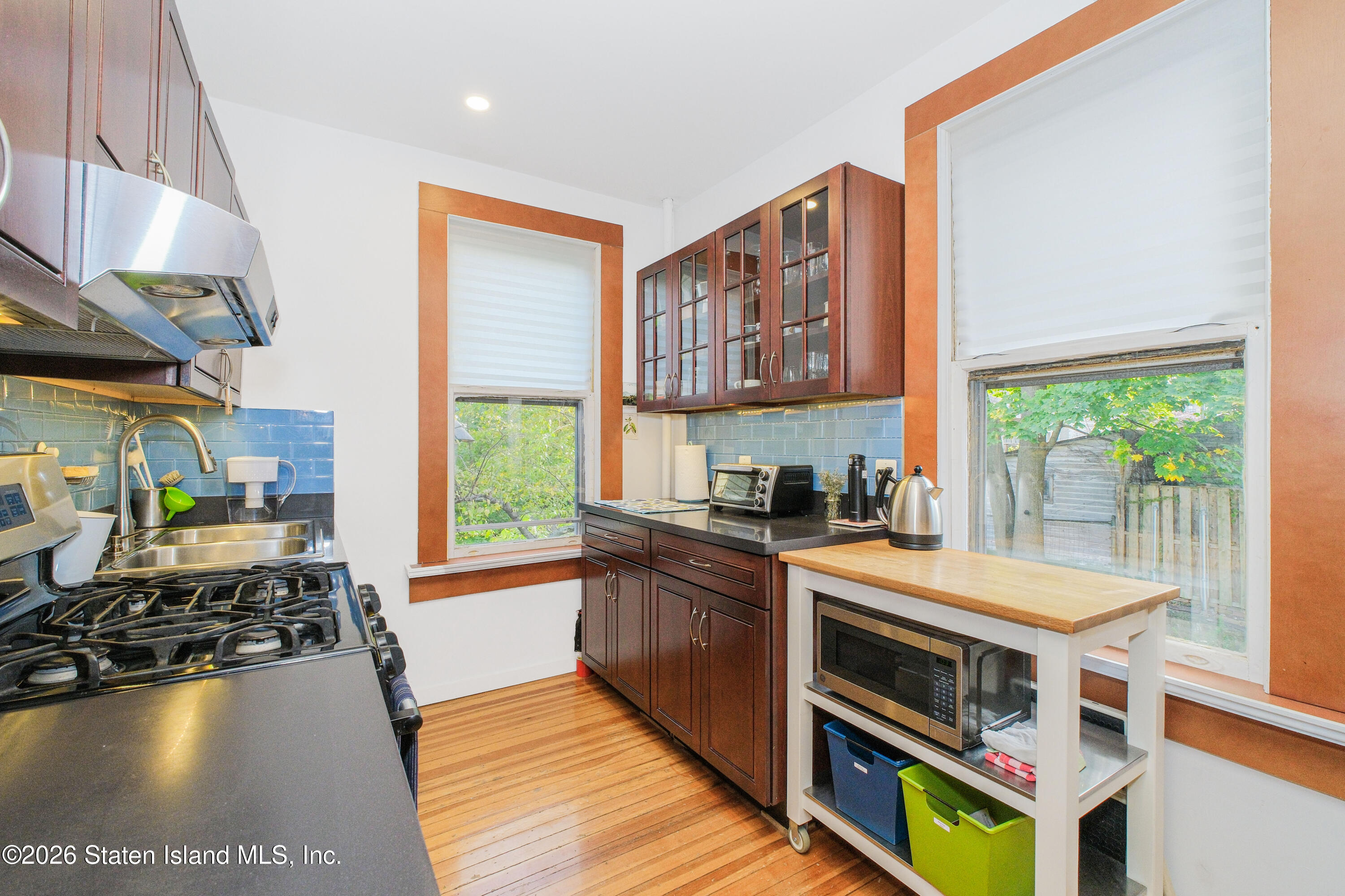 98 Hamilton Avenue Staten Island, NY 10301 - Photo 33 of 55 a kitchen with stainless steel appliances a stove a sink and a microwave
