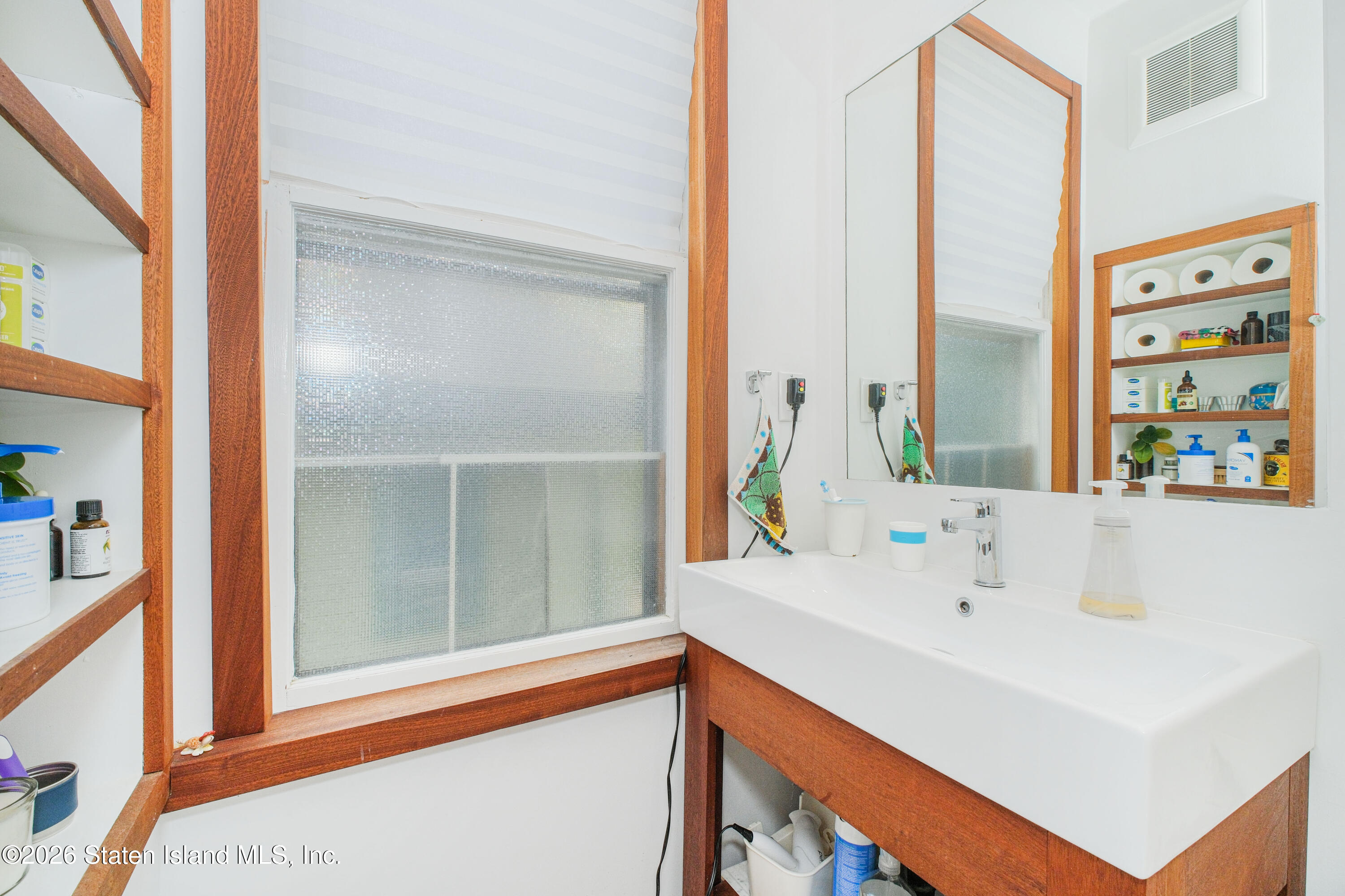 98 Hamilton Avenue Staten Island, NY 10301 - Photo 38 of 55 a bathroom with a sink and a large mirror
