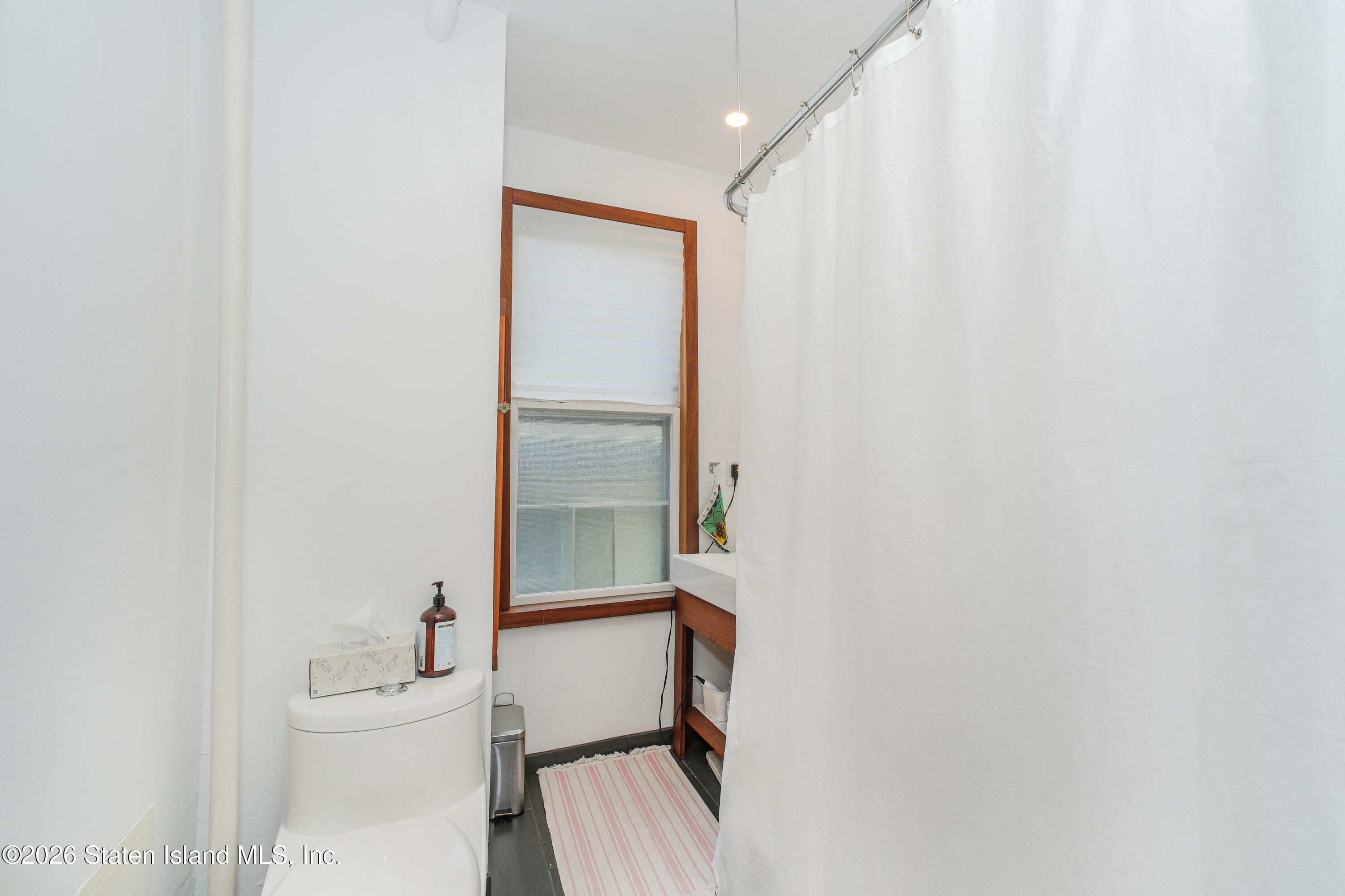 98 Hamilton Avenue Staten Island, NY 10301 - Photo 39 of 55 a bathroom with a sink a toilet and shower