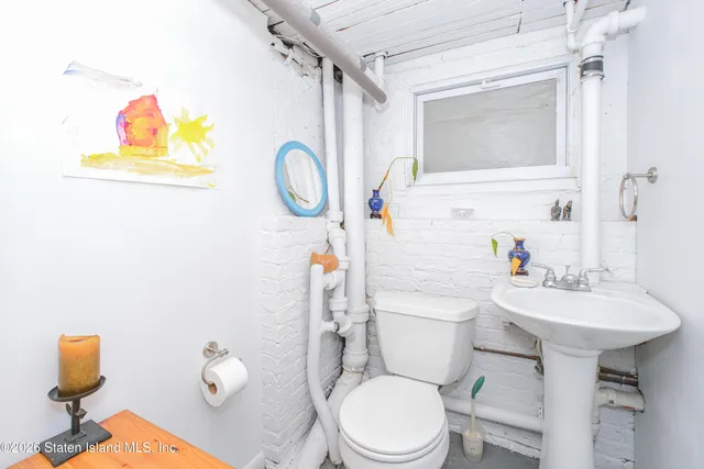 a view of a white house with a big yard and potted plants