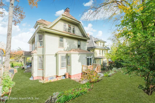 a view of backyard with a garden and deck