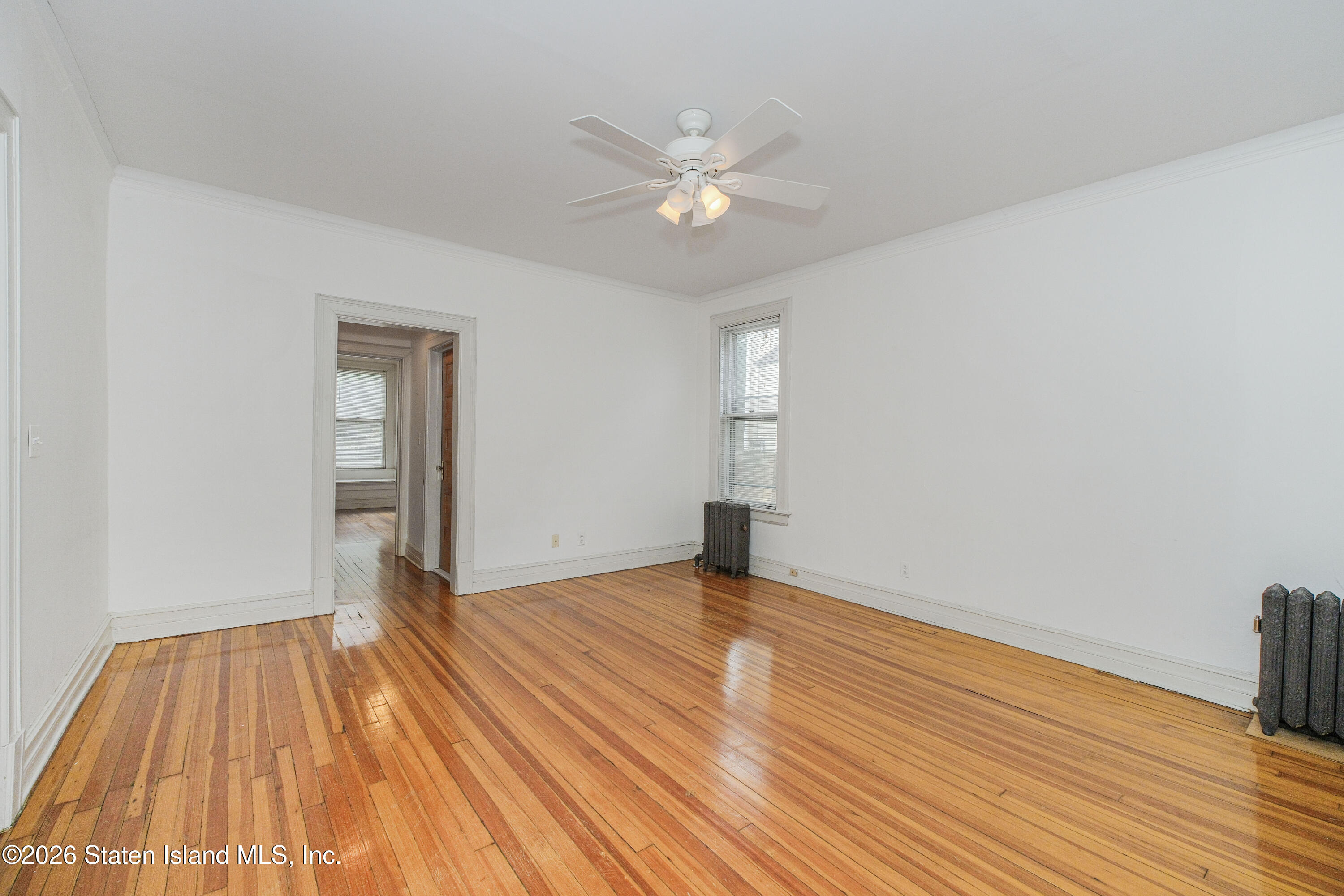 98 Hamilton Avenue Staten Island, NY 10301 - Photo 7 of 55 wooden floor in an empty room with a window