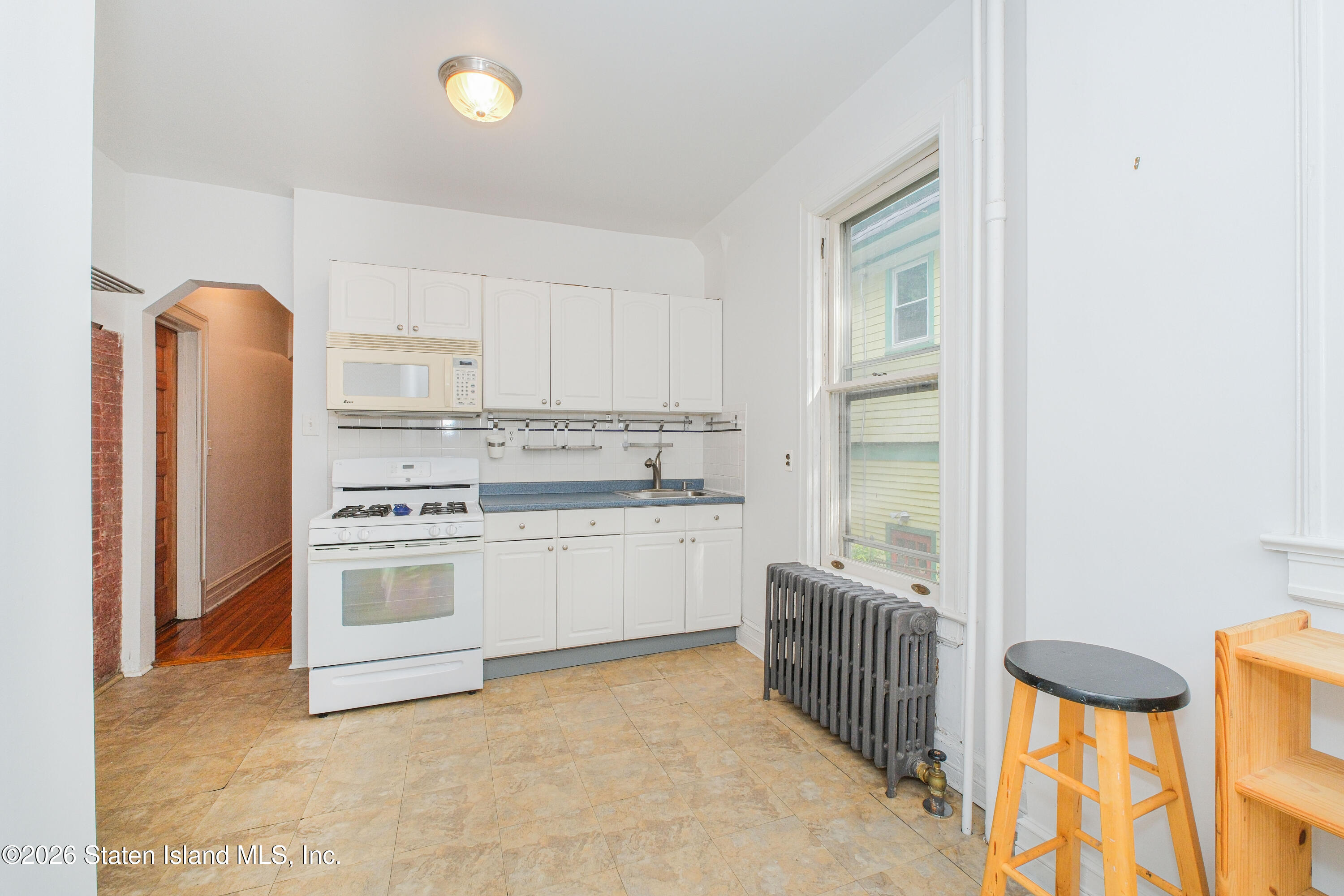 98 Hamilton Avenue Staten Island, NY 10301 - Photo 8 of 55 a kitchen with stainless steel appliances a stove a sink and a refrigerator