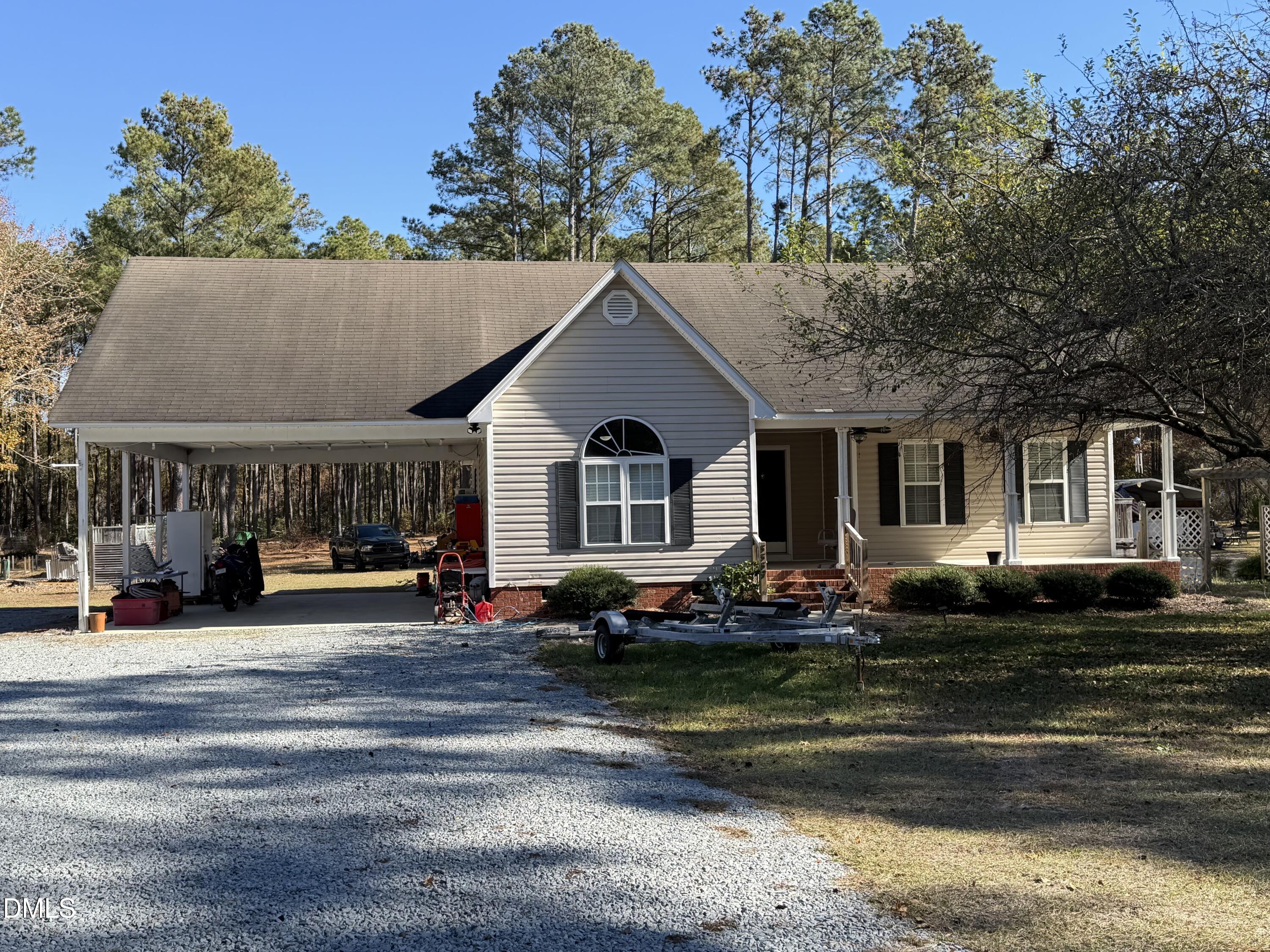 a front view of a house with trees in the background