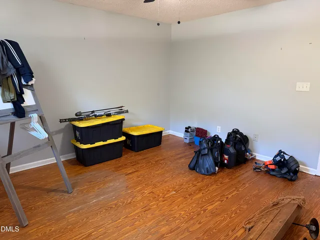 a living room with furniture and a gym equipment