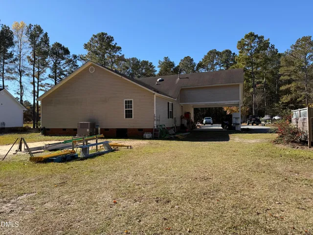 a view of a house with swimming pool and sitting area