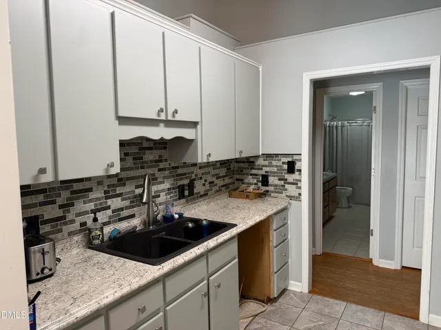 a kitchen with a sink and a stove top oven