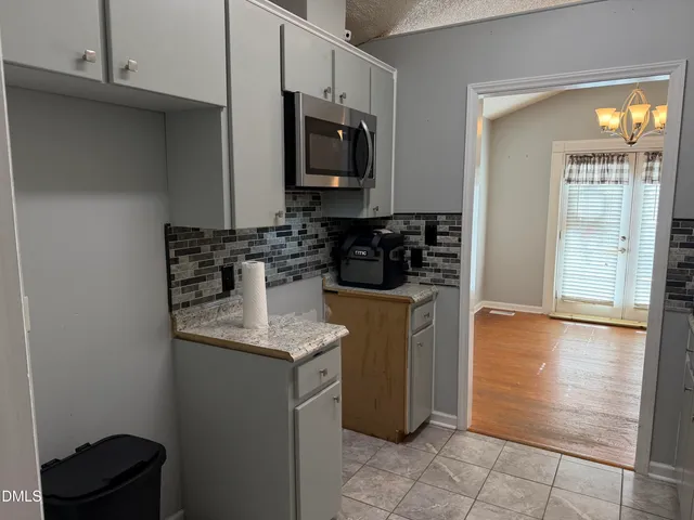 a kitchen with stainless steel appliances granite countertop a sink and a stove