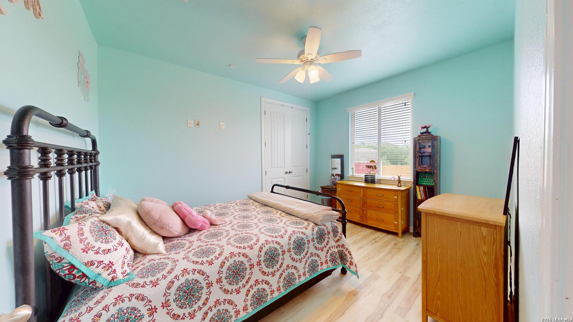10111 Shallow Bank Converse, TX 78109 - Photo 29 of 65 a bedroom with a bed wooden floor and lamp