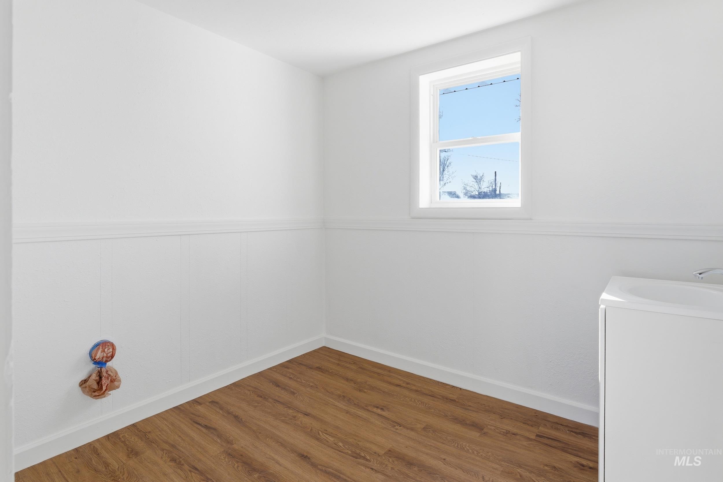 107 West Main Street Declo, ID 83323 - Photo 12 of 32 Laundry area featuring wood finished floors and baseboards