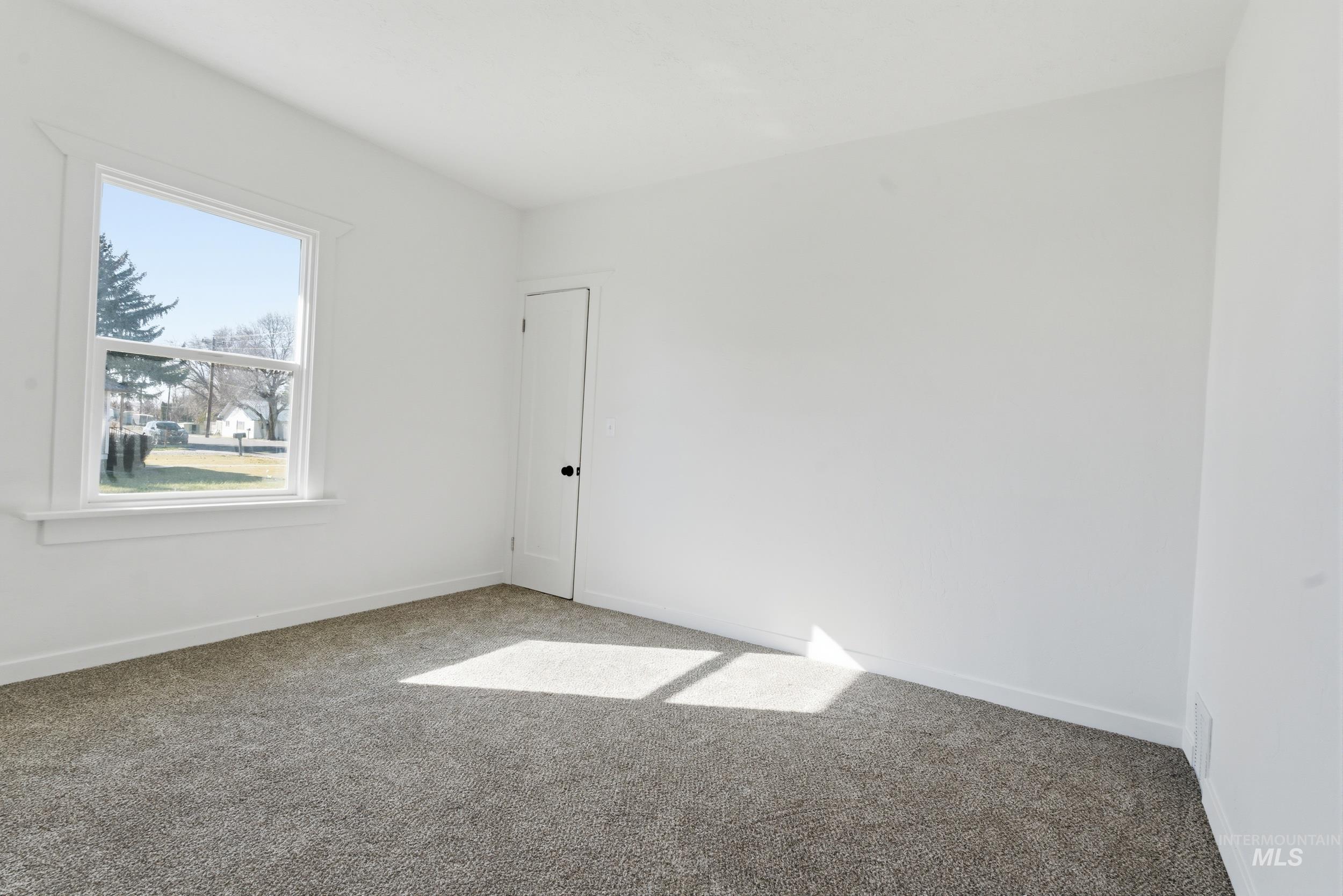 107 West Main Street Declo, ID 83323 - Photo 14 of 32 Unfurnished room with baseboards and carpet flooring